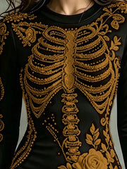 Close detail of gold skeleton print on black long sleeve bodycon dress bodice