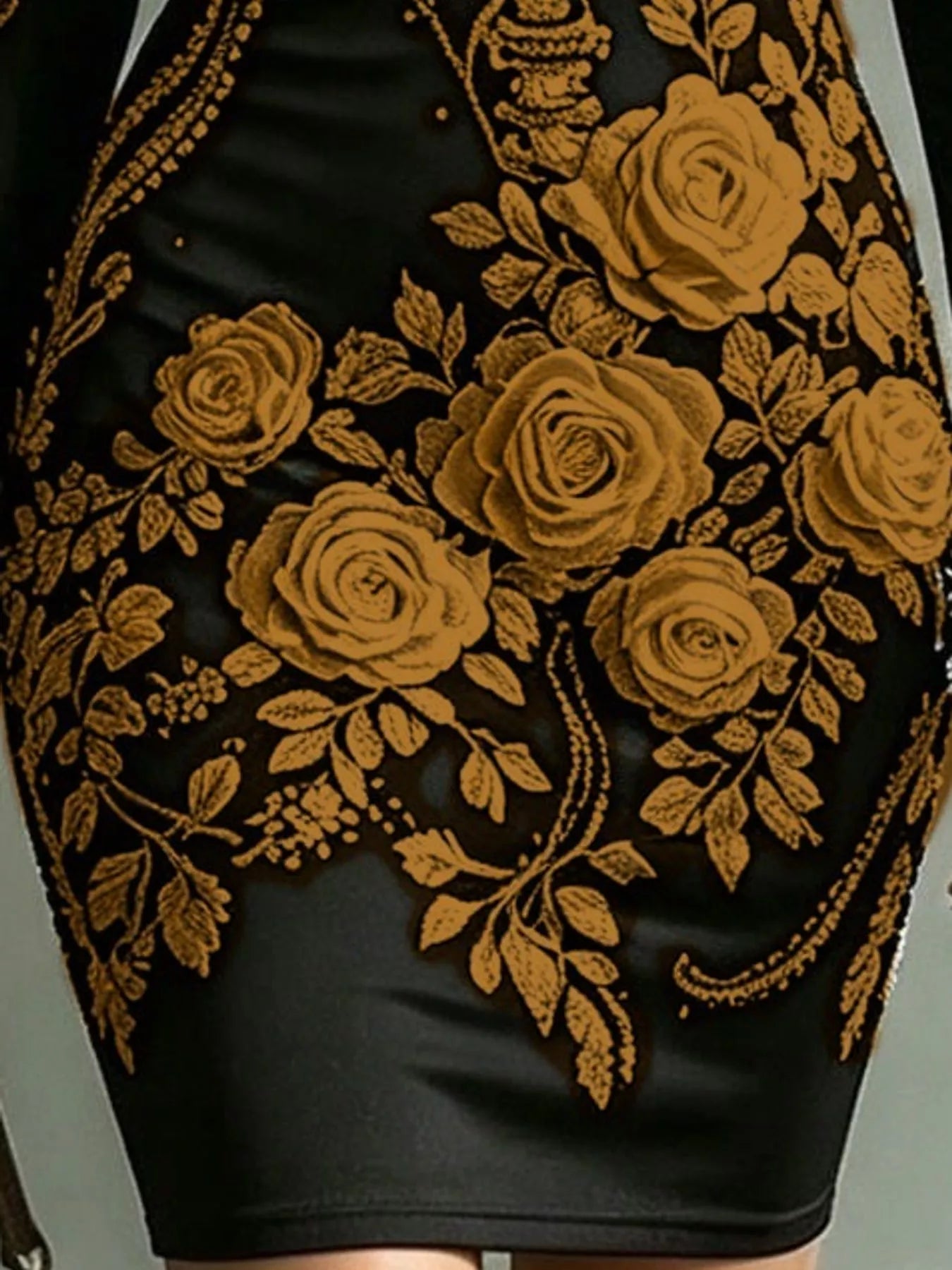 Close detail of gold rose print on black long sleeve bodycon dress skirt
