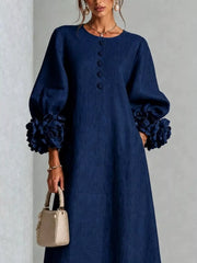 Close front view of the navy round neck midi dress bodice with small floral buttons and floral cuffs