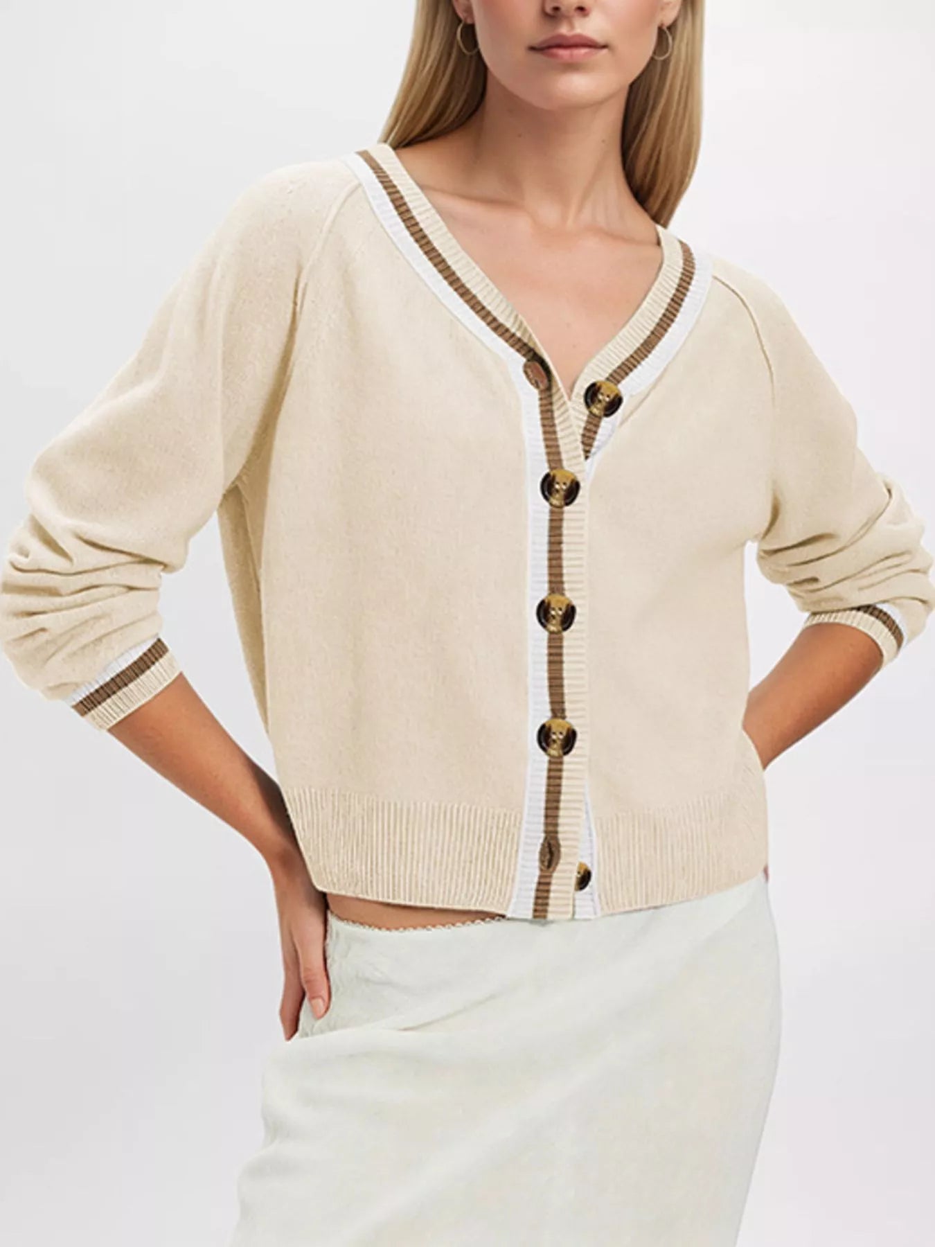 On-model front view of apricot button down cardigan with brown and white striped trim