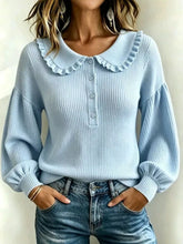 Front view of sky blue ribbed sweater with ruffle collar and balloon sleeves worn with jeans