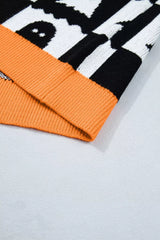 Close up of an orange ribbed hem on a black and white ghost checkerboard sweater