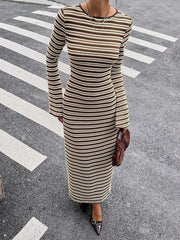 On-model front view of a brown and cream striped sweater dress with flared sleeves