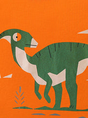 Close view of the green dinosaur graphic with cream belly and small plant detail on orange fabric