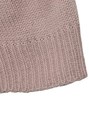 Close up of the pink ribbed hem of a knit sweater