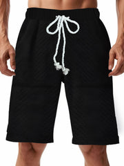 Men's black textured shorts with a drawstring waist and pockets.