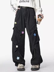 Men's black wide-leg pants with an oversized fit and pockets.