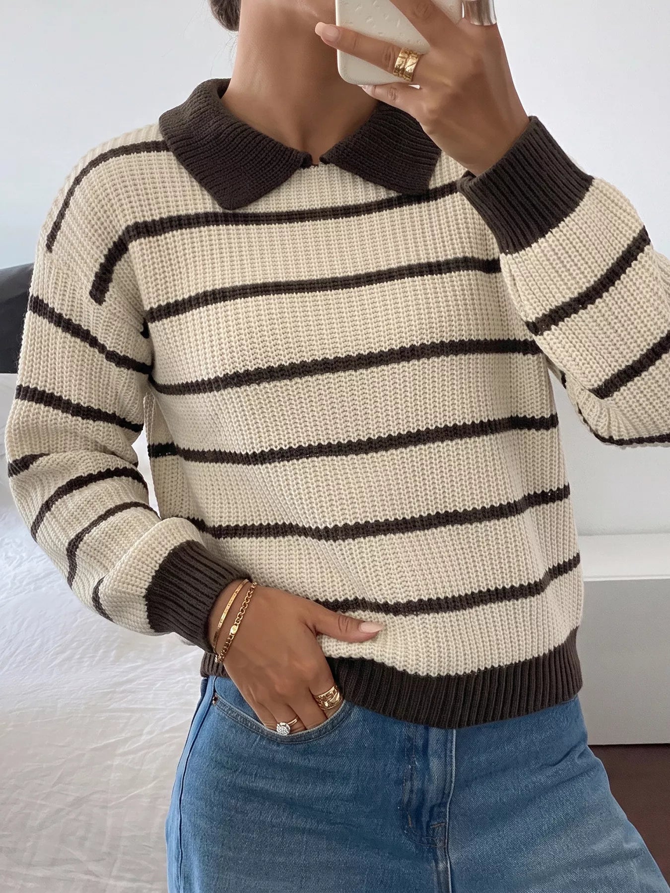 Front mirror view of a cream and brown striped knit polo sweater with brown collar.