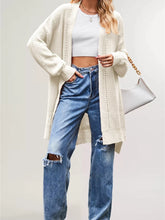 Cream long open front cardigan with openwork stripes worn over jeans
