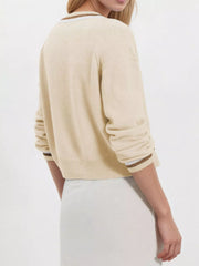 Back view on-model of apricot button down cardigan with brown and white striped cuffs
