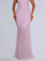 Lower view of blush pink ruched bodycon maxi dress showing the flowing skirt