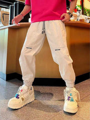 Men's off-white cotton-blend joggers with a drawstring waist and pockets.