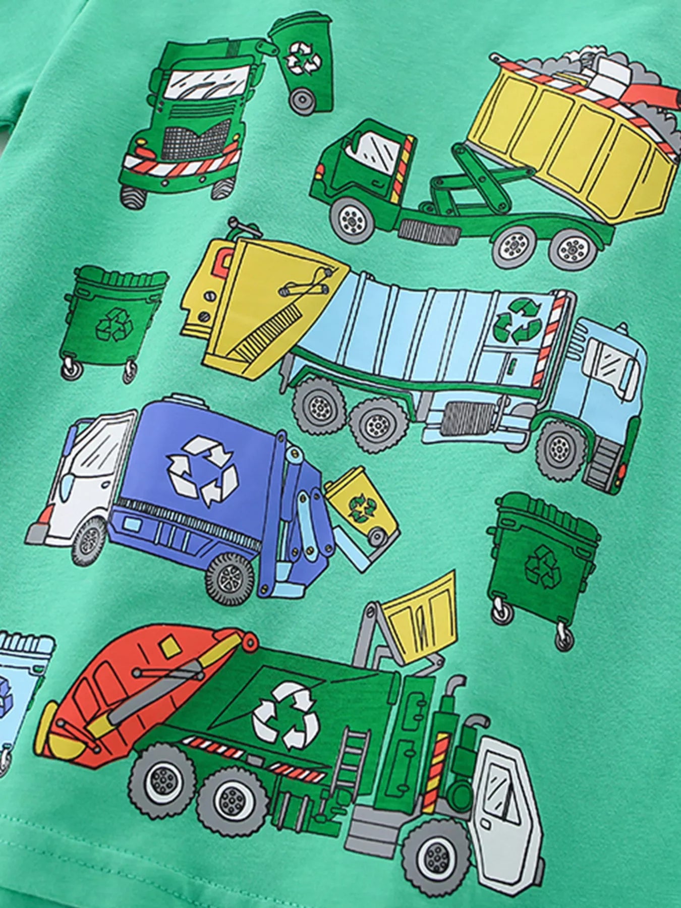 Close-up of the cartoon garbage truck and recycling bin print across the green children's T-shirt