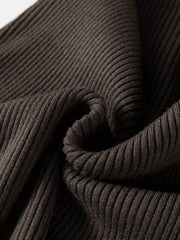 Close up of folded coffee brown ribbed knit fabric on sweater vest
