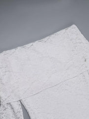 Flat detail view of a white lace maxi dress showing the bodice and skirt seam