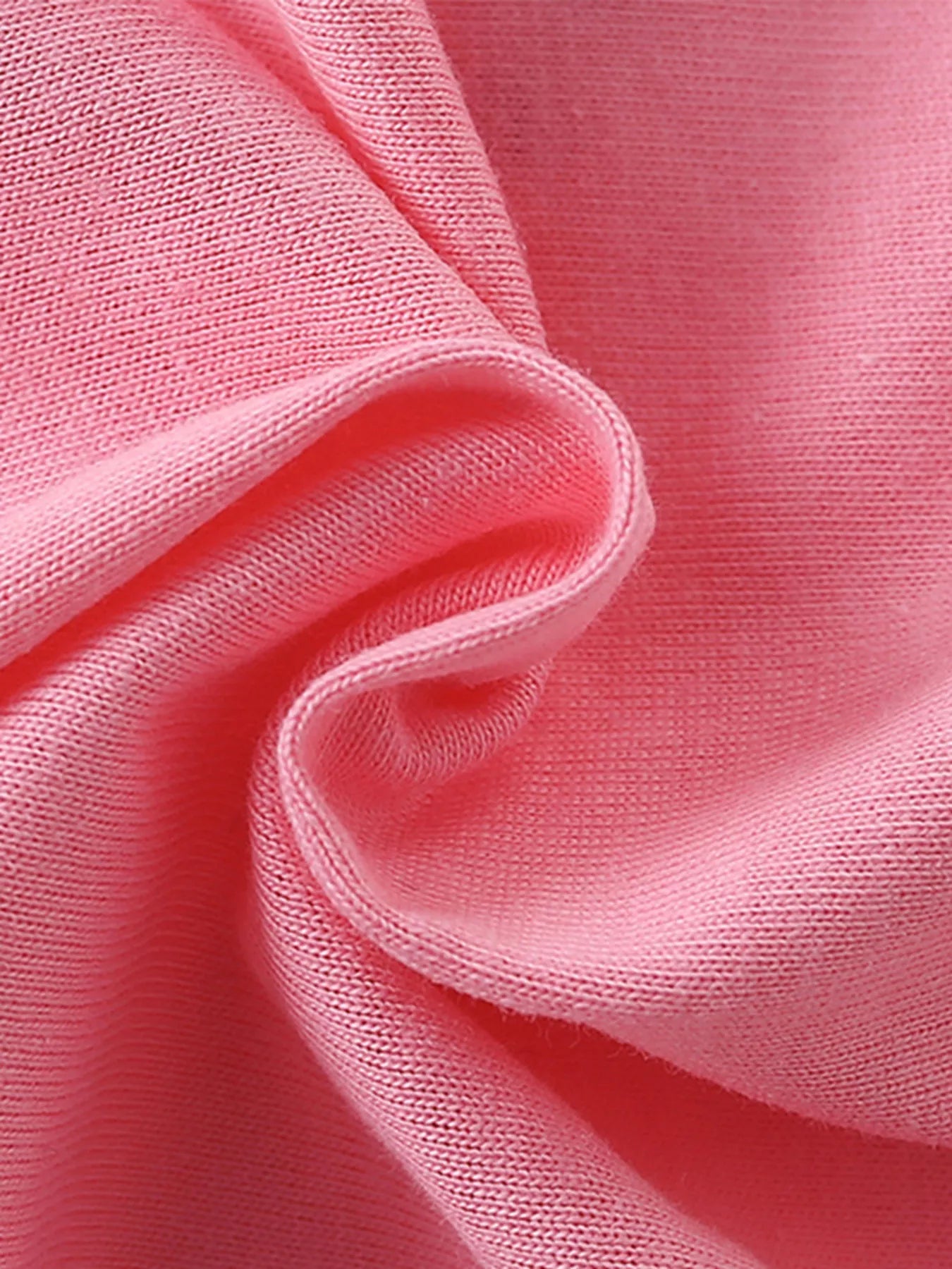 Close-up texture of the soft pink fabric of the children's short sleeve shirt