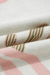 Close-up of folded cream knit fabric with green cactus and pink wave detail