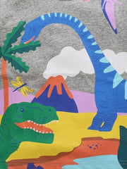 Close-up detail of the dinosaur print with a long-necked blue dinosaur and volcano