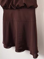 Brown mini dress detail showing waistband and tiered flared skirt on hanger