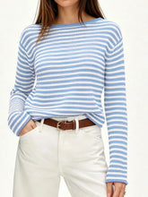 On-model front view of a light blue and white striped boat neck sweater with long sleeves