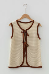 Flat lay front view of a beige tie front sweater vest with brown contrast trim on hanger
