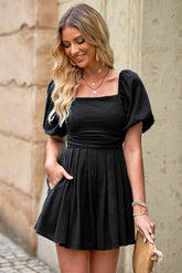 Women's romper with a square neckline, pleated detailing, and pockets.