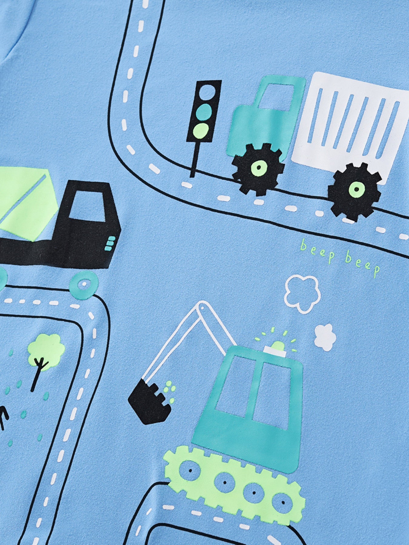 Close view of the truck and excavator road graphic on the sky blue children's t-shirt