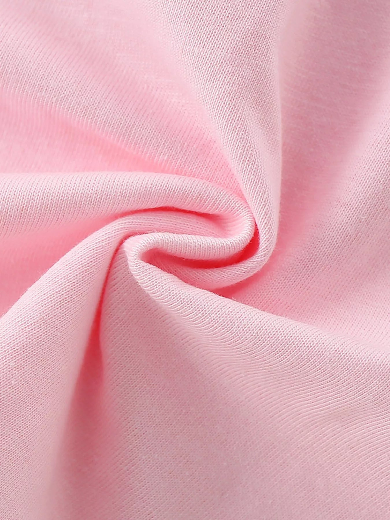 Close-up of the soft blush pink fabric showing its texture and drape