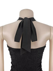 Close back detail of black halter maxi dress showing tied neck strap and smocked bodice