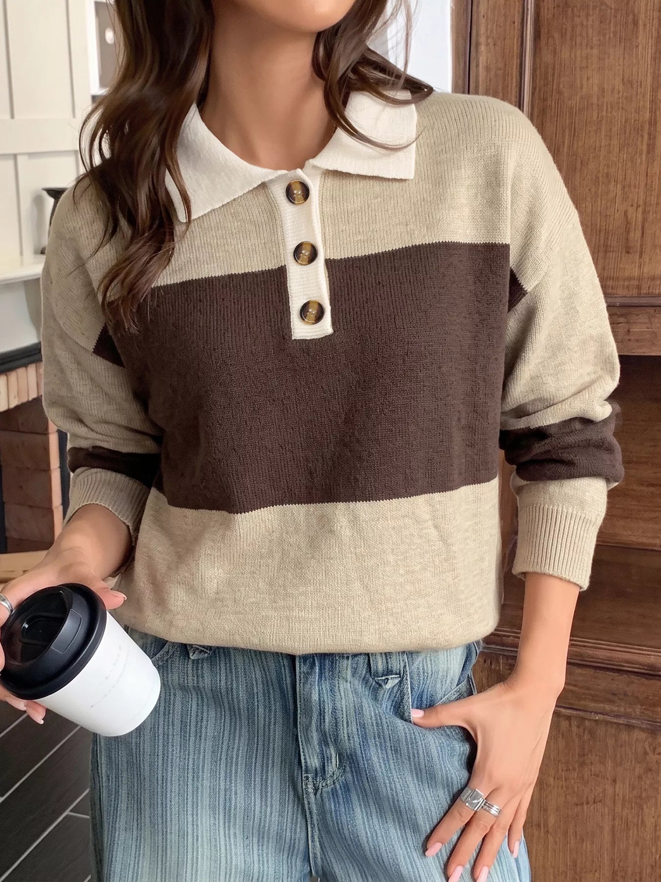 Front view of beige and brown polo sweater with tortoiseshell buttons and cream placket.