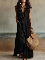 Black sleeveless button down linen maxi dress in full front view with woven tote bag