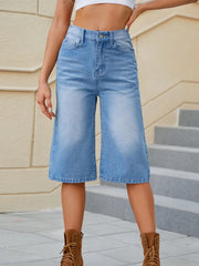 Women's high-waisted denim shorts with button fastening and pockets.