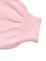 Close-up of a ribbed pink sweater cuff on a soft fuzzy knit sleeve