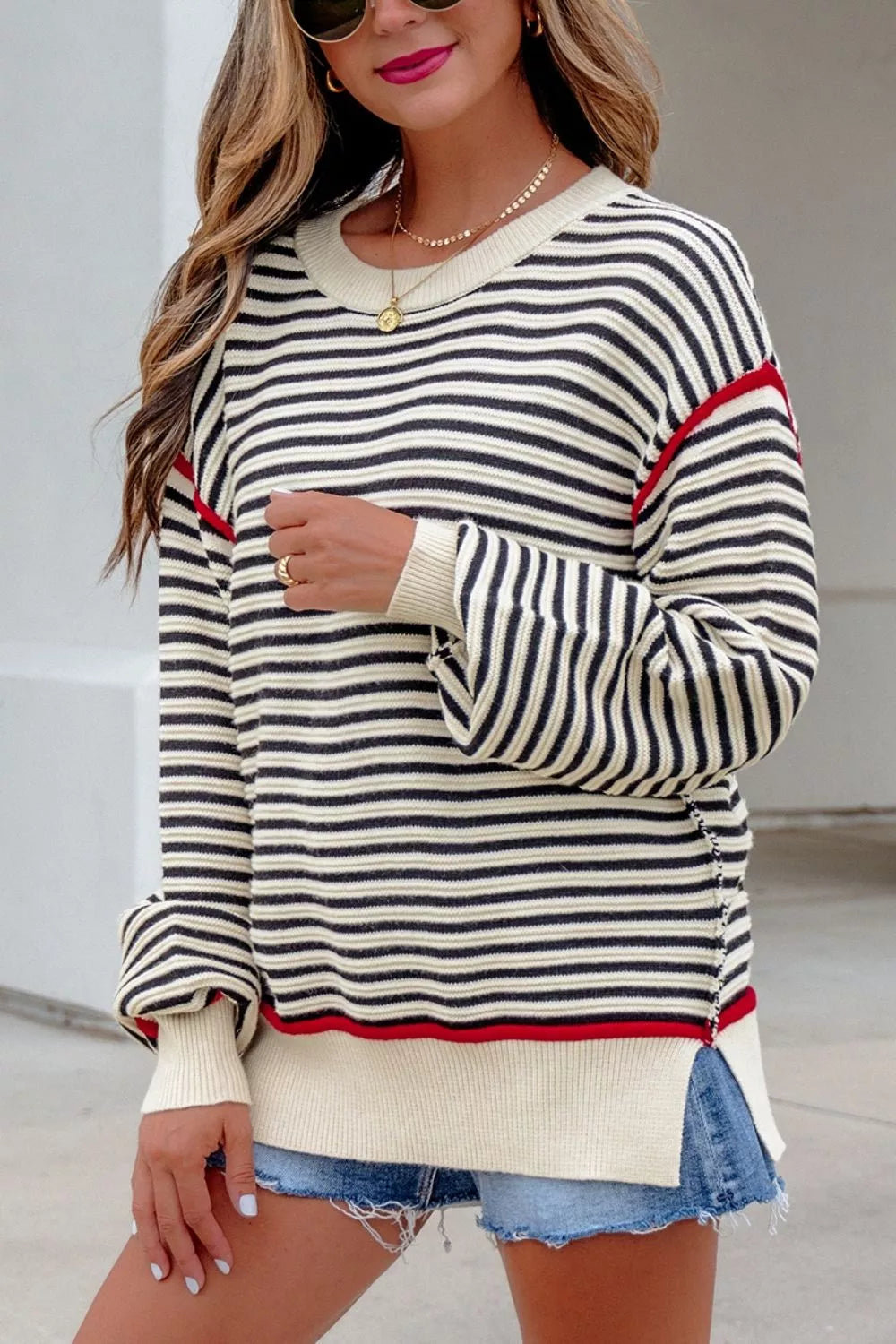Closer on-model front view of the striped oversized sweater with red shoulder seam detail