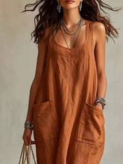 Cropped front view of brown sleeveless scoop neck maxi dress, showing neckline and large pockets