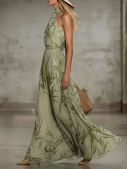 Side view of a matcha leaf print sleeveless chiffon maxi dress with a flowing long skirt