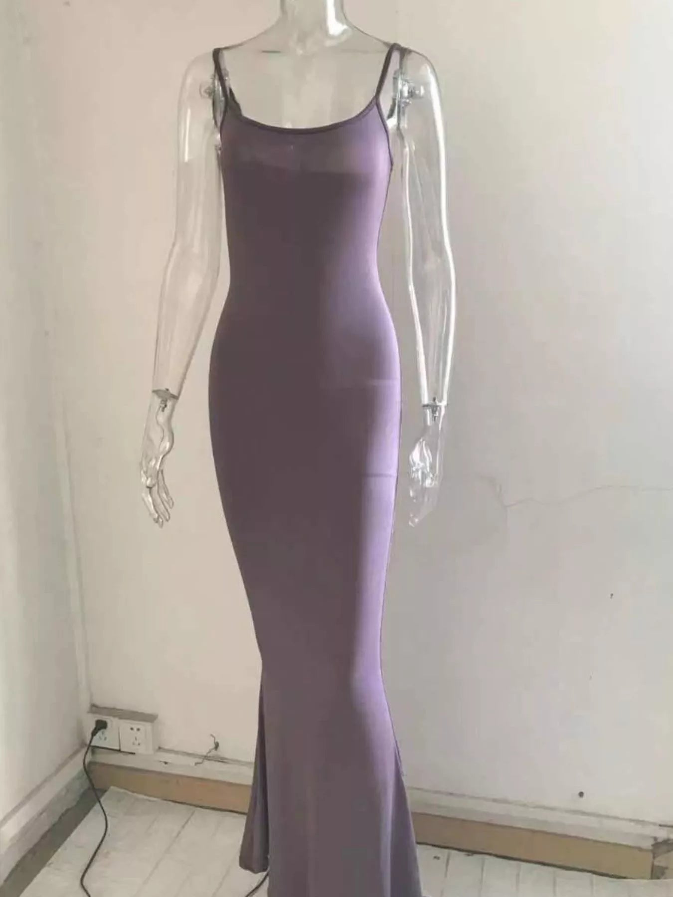 Front view of a mauve spaghetti strap bodycon maxi dress displayed on a clear mannequin indoors