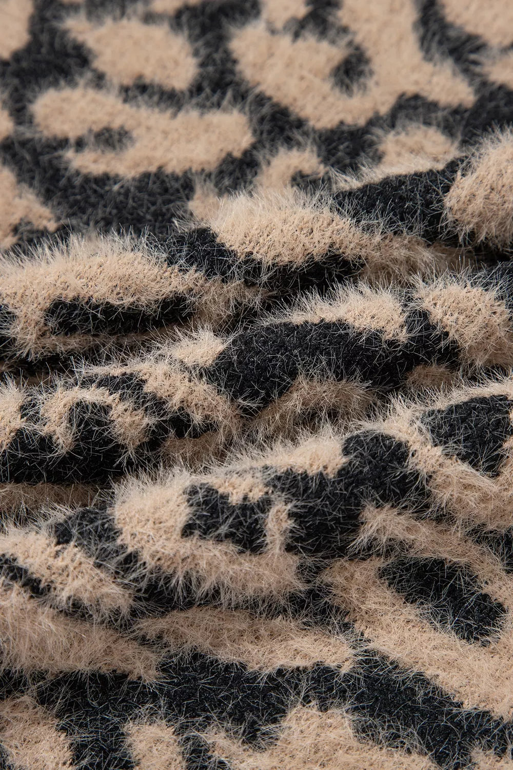 Close up of fuzzy tan and black leopard print knit texture.