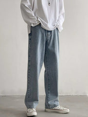 Men's Air Force Blue loose fit wash jeans on model, front view with hands in pockets.