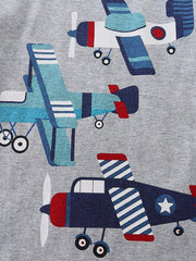 Close-up of colorful cartoon airplane print on light gray children's t-shirt fabric