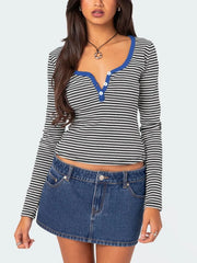 Black and white striped long sleeve t shirt with royal blue trim and white buttons worn on model front view