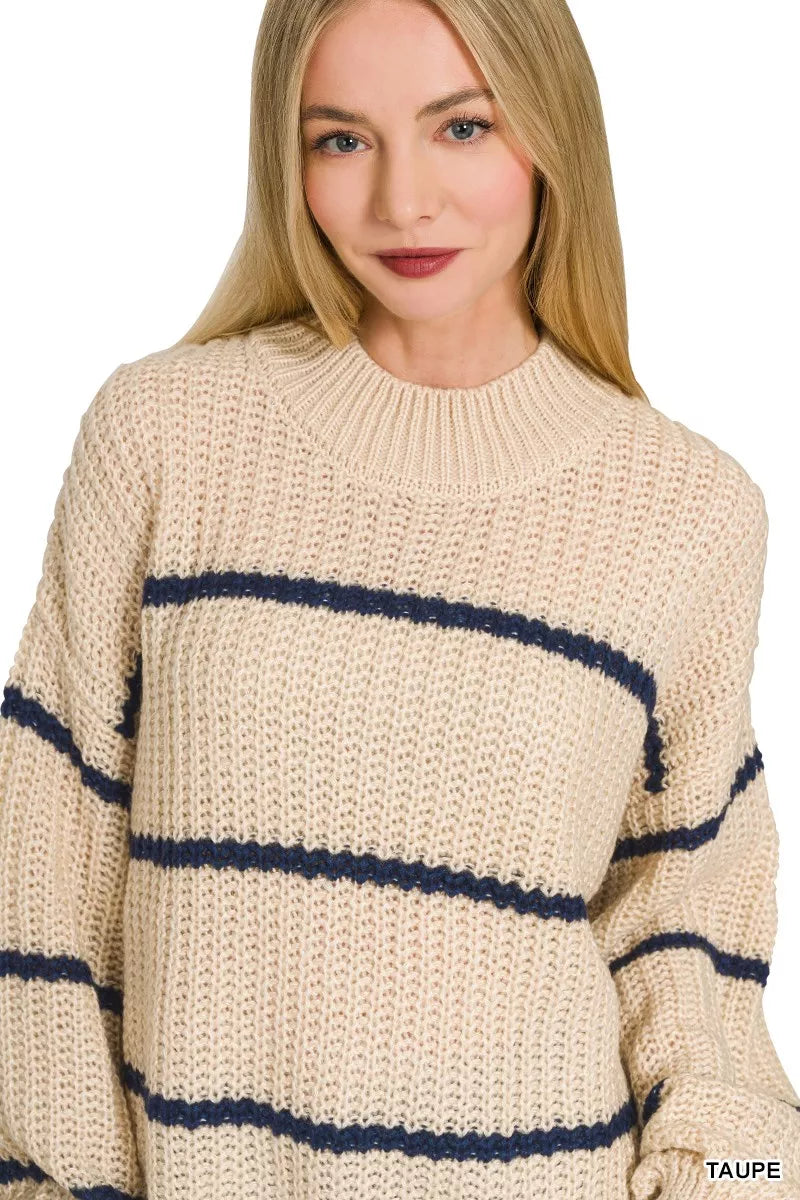 Close front view of cream striped oversize sweater showing mock neck and knit texture