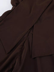 Brown mini dress fabric detail showing layered skirt seam and smooth texture