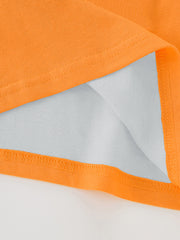 Close-up of the hem stitching and inner fabric on an orange children's excavator graphic T-shirt