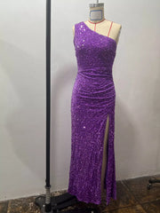 Purple sequin one shoulder evening dress shown front facing on a dress form with a high slit