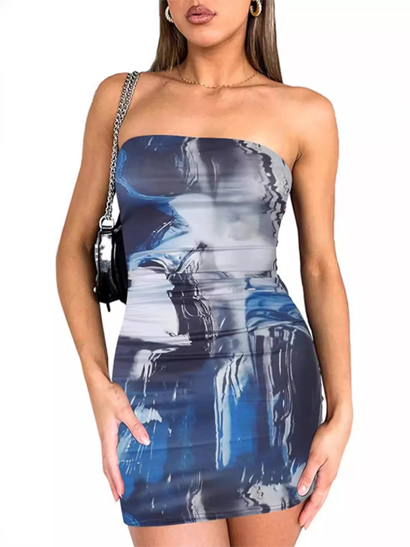 Model wearing a strapless dark blue and white abstract tie dye mini dress, front view