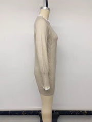 Side view of beige cable knit sweater dress on a mannequin showing lace cuffs and ribbed hem