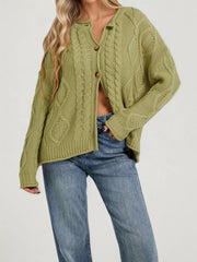 Front view of green cable knit button down cardigan with brown buttons and blue jeans