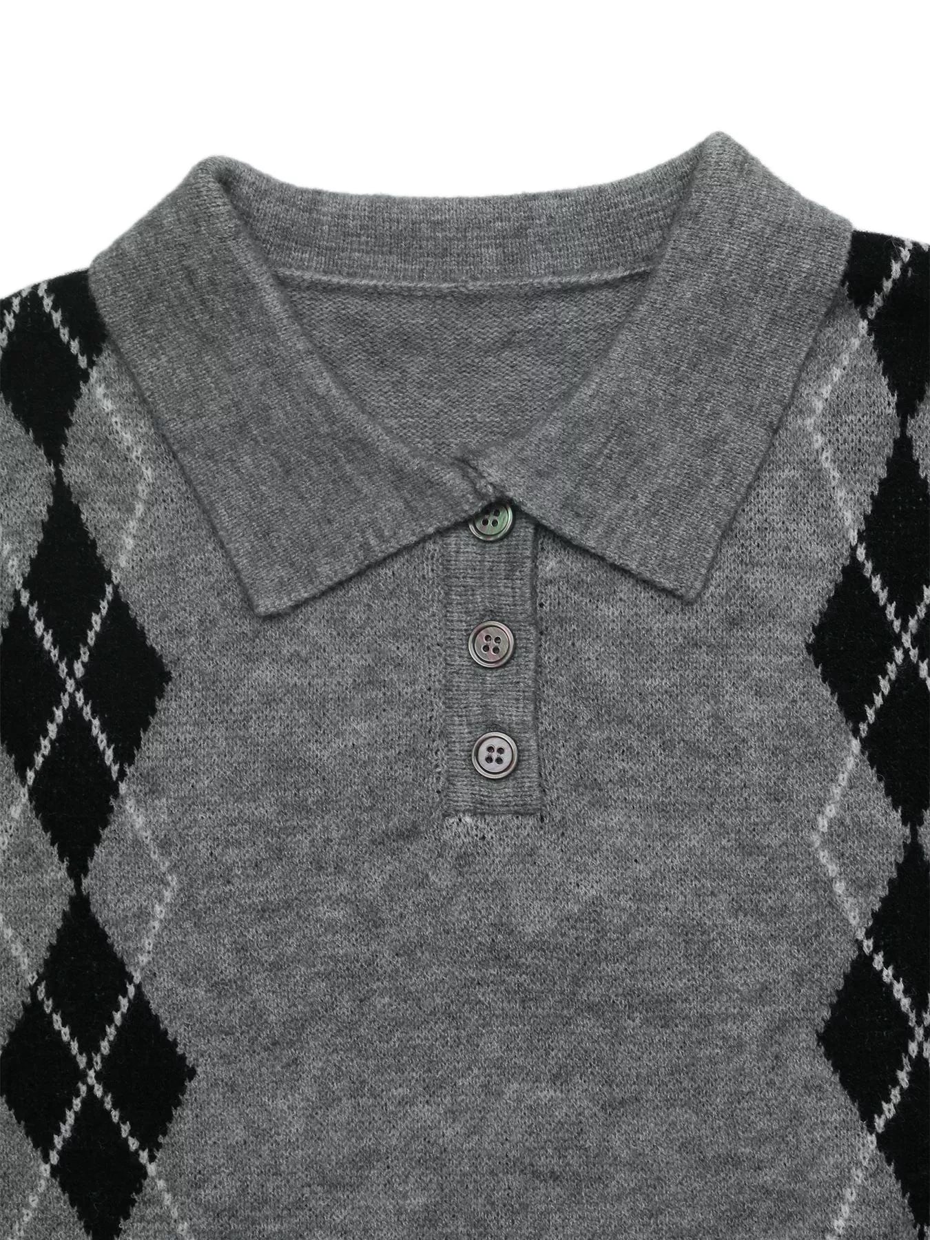 Close-up flat lay of a gray polo collar with three buttons and black argyle shoulders