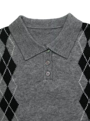 Close-up flat lay of a gray polo collar with three buttons and black argyle shoulders